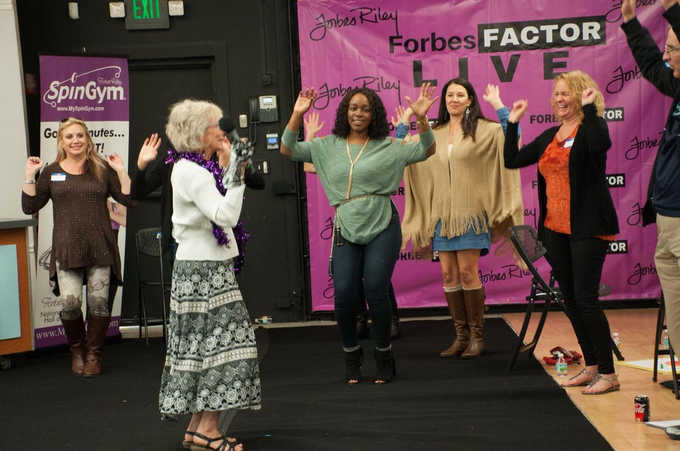 Attendees cheering on stage at Forbes Factor Live