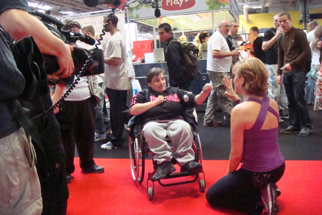 Forbes coaching a SpinGym workout from a wheelchair